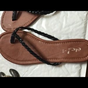 Tan flip flops with black braided straps